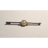 Gold-coloured metal, pearl and diamond bar brooch, set single circular pearl flanked by two small