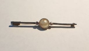 Gold-coloured metal, pearl and diamond bar brooch, set single circular pearl flanked by two small