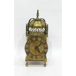 Brass mantel clock with Roman numerals to the chapter ring, turned feet