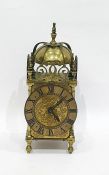 Brass mantel clock with Roman numerals to the chapter ring, turned feet