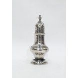 Victorian silver pepperette, Birmingham 1886, pear-shaped and crested, on circular foot, makers