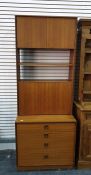 G-Plan lounge unit in teak, with two cupboard doors above two shelves above four enclosing shelf, on