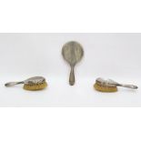 Three piece silver-backed dressing table set with engine-turned decoration and monogram,