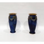 Pair of Royal Doulton stoneware vases of baluster form decorated with garlands, on a mottled blue