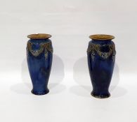 Pair of Royal Doulton stoneware vases of baluster form decorated with garlands, on a mottled blue