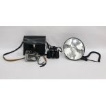 Yashica 8-E III camera, a pair of Boots Admiral 8x30 field binoculars and a spot lamp