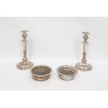 Pair of silver plated candlesticks with baluster stems and circular feet and a pair of silver plated