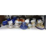 Assorted cups and saucers including blue and white, Colclough, Churchill, china, etc (1 shelf)