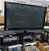 An LG flatscreen television, 50" and a smoked glass television stand (2)