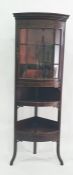 A 19th century mahogany bowfront display corner cabinet, the top with single glazed bowfront door