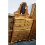 A 20th century pine chest of seven assorted drawers, to bracket feet and a dressing table mirror (2)
