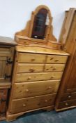 A 20th century pine chest of seven assorted drawers, to bracket feet and a dressing table mirror (2)