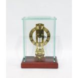 Modern glass cased mantel clock with Roman numerals to the brass dial