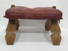 Camel stool with red leather seat