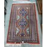 Modern Persian style rust ground rug, two lozenge medallions geometric border in shades of green and