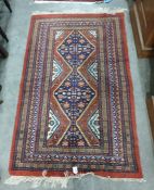 Modern Persian style rust ground rug, two lozenge medallions geometric border in shades of green and