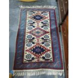 Modern Persian style wool rug having three stepped lozenges to a cream ground all in shades of