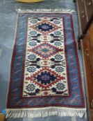 Modern Persian style wool rug having three stepped lozenges to a cream ground all in shades of