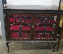 A 19th century mahogany display cabinet, the moulded edge above carved frieze, glazed doors