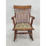Spindle back beech-framed rocking chair with upholstered seat
