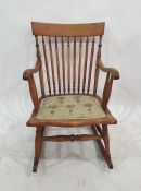 Spindle back beech-framed rocking chair with upholstered seat