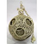 19th century Chinese carved ivory puzzle ball on stand, the ball surmounted by Dog of Fo, the