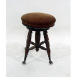 A Victorian adjustable circular piano stool, the padded seat on extending column, ribbed and