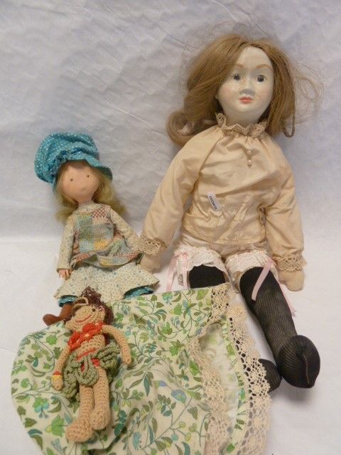 A replica of a Victorian papiermache doll, with a foam body, together with a 'country' doll and a