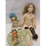 A replica of a Victorian papiermache doll, with a foam body, together with a 'country' doll and a