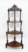 Victorian walnut four-tier waterfall whatnot with turned columns uniting the tiers, 139cm