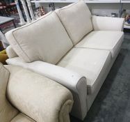 A two-seat cream-coloured upholstered sofa bed  Condition ReportThe length is 170 cm.