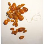 Quantity of amber graduated oval beads, unstrung,