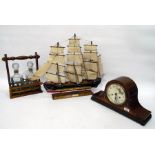 Mahogany mantel clock in Napoleon's hat shaped case, with chiming movement, two bottle tantalus