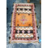 Orange ground carpet with central medallion, in oranges, creams, pinks and browns, 145cm x 82cm