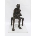 Bronze-effect sculpture of figure with child upon