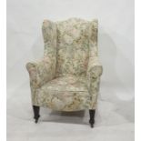 19th century wing back armchair in cream ground foliate patterned upholstery, raised on square