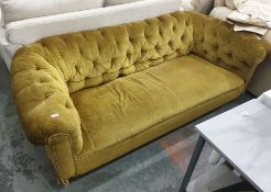 A Victorian button-back Chesterfield sofa in olive green upholstery, on turned supports to castors