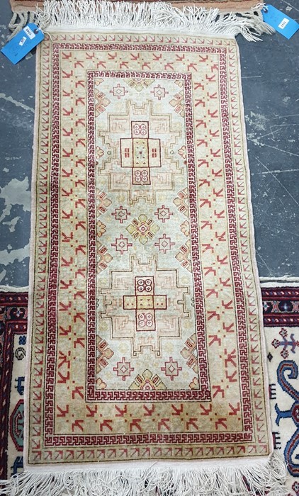 Modern silk Eastern wool rug in geometric decoration in shades of red on cream ground