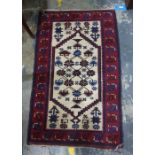 Cream ground rug with foliate motifs, on a red ground border, 131cm x 79cm