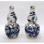 Pair Oriental blue and white porcelain covered vases each double-gourd shape painted with birds on