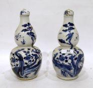 Pair Oriental blue and white porcelain covered vases each double-gourd shape painted with birds on