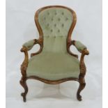 19th century armchair, the spoon-shaped back with light green button back upholstery, carved hand