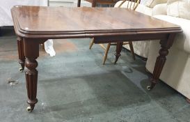 A early Victorian extending mahogany dining table, the moulded edge above turned and reeded