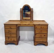 A 20th century pine dressing table of eight drawers, to bracket feet, a bedside cabinet with