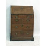 A 18th century oak bureau of one long above two short above two long drawers, with brass swan neck