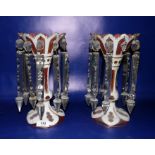 Pair cranberry gilt and white overlay glass lustres, each having shaped scalloped everted rim,