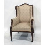 Mahogany and inlaid wingback chair in a pale ground patterned upholstery, square section tapering