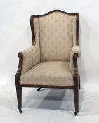Mahogany and inlaid wingback chair in a pale ground patterned upholstery, square section tapering