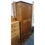 A 20th century pine two-door wardrobe above two drawers, 75cm x 181.5cm