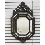 Dutch-style embossed metal antique wall mirror with ornate shell and pierced scroll pediment, the